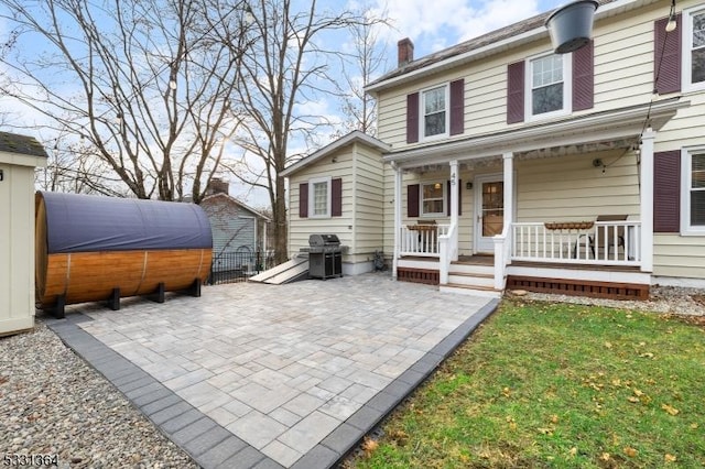 rear view of property featuring a patio