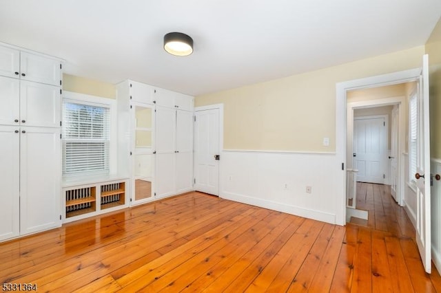 unfurnished bedroom with light wood-type flooring