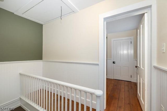 corridor with hardwood / wood-style flooring