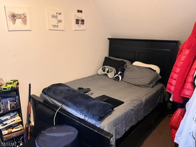 carpeted bedroom with vaulted ceiling