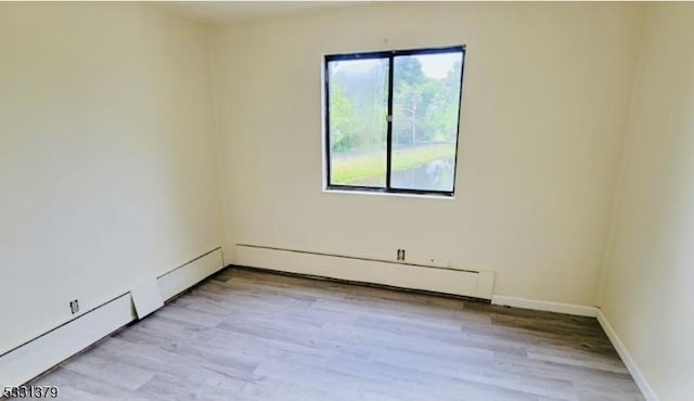 spare room featuring plenty of natural light and light hardwood / wood-style floors