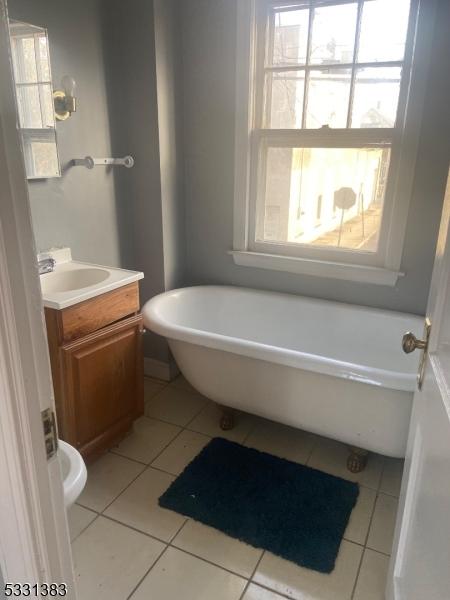 bathroom featuring tile patterned floors, a bathtub, and vanity