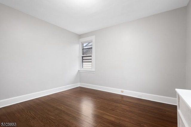 empty room featuring dark wood-type flooring