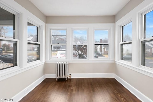 unfurnished sunroom featuring radiator heating unit