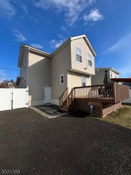 back of house with a wooden deck