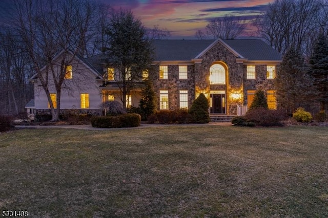 colonial inspired home with a lawn