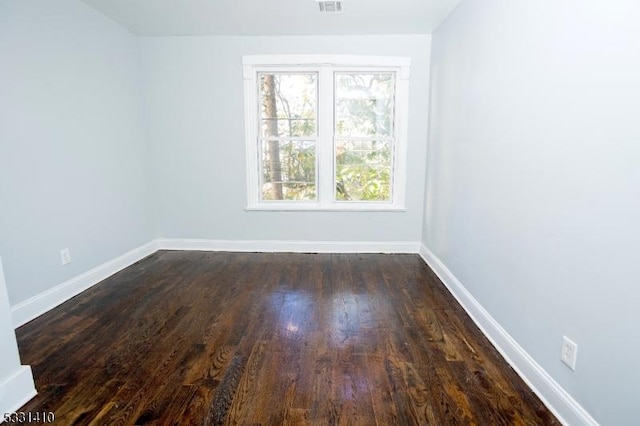 unfurnished room featuring dark wood-type flooring