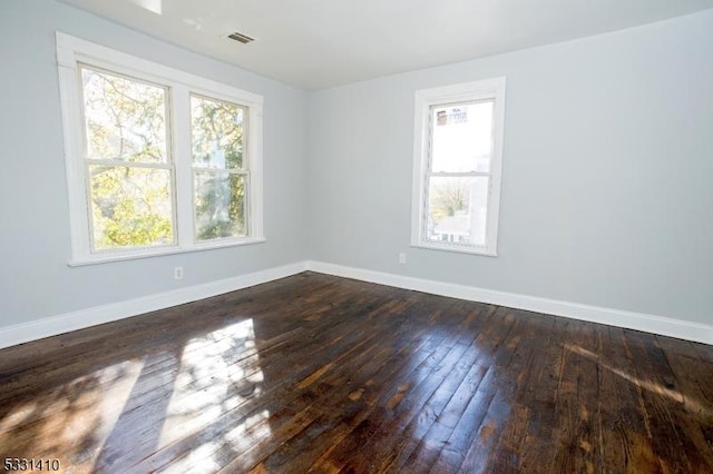 unfurnished room featuring dark hardwood / wood-style flooring