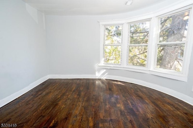 empty room with hardwood / wood-style flooring