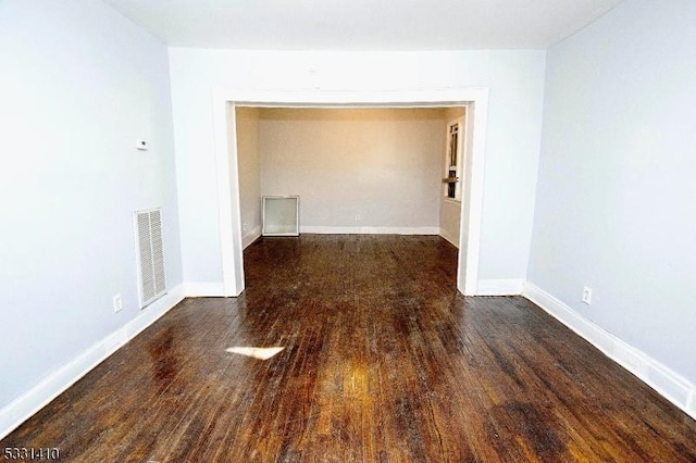 unfurnished room featuring dark hardwood / wood-style flooring