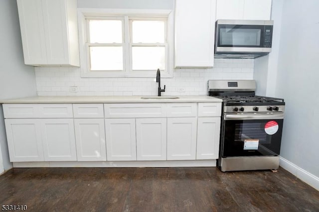 kitchen featuring dark wood-type flooring, white cabinetry, sink, and stainless steel appliances