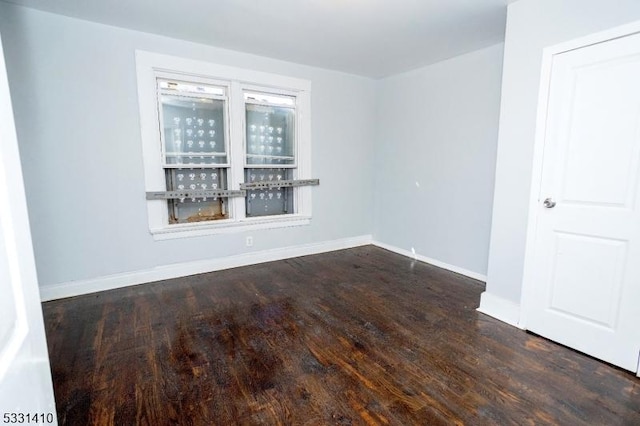 empty room featuring dark hardwood / wood-style flooring