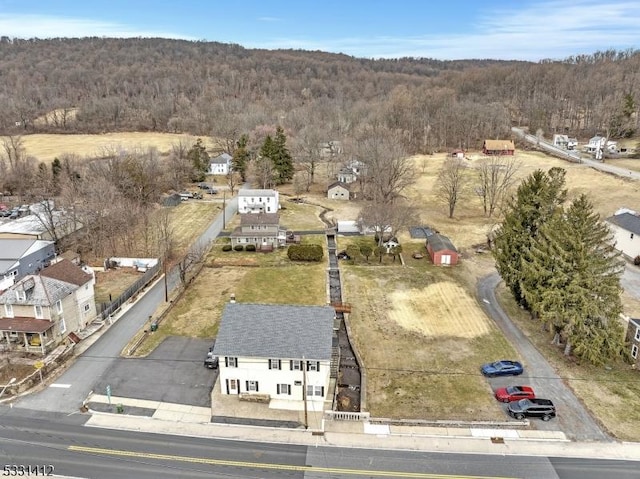 birds eye view of property with a view of trees