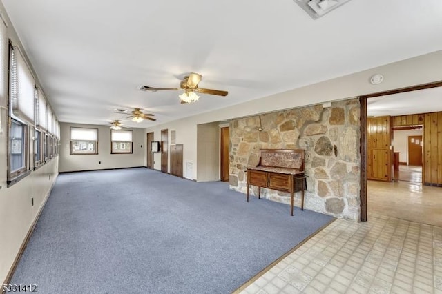 unfurnished living room featuring visible vents, ceiling fan, and carpet