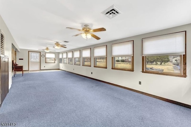 empty room featuring visible vents, carpet, and baseboards