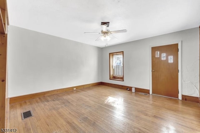 interior space with visible vents, a ceiling fan, and hardwood / wood-style flooring