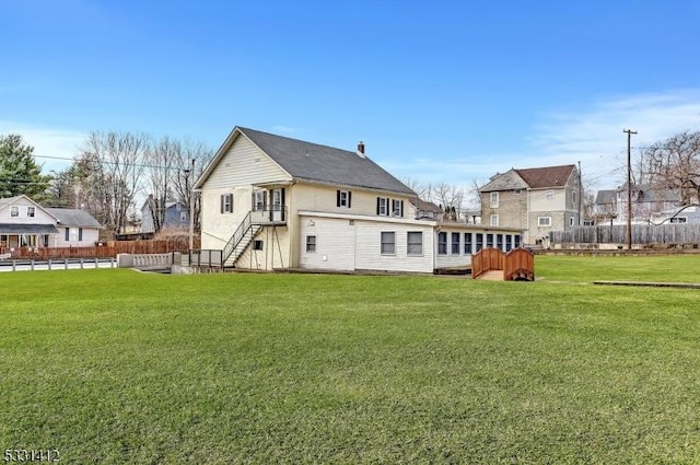 back of house with stairway and a lawn