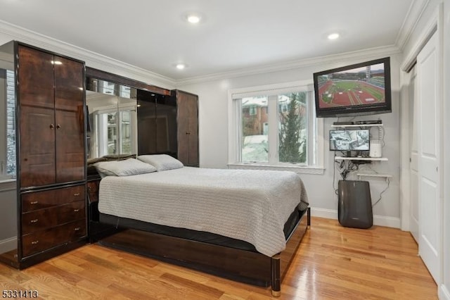 bedroom featuring light wood-type flooring and crown molding