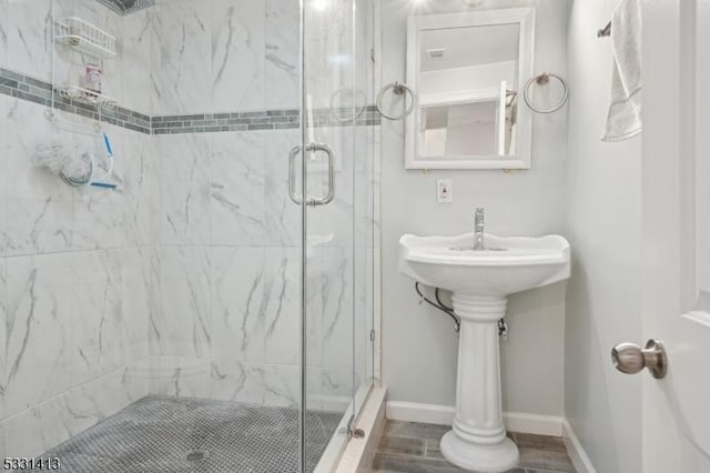 bathroom with a shower with door