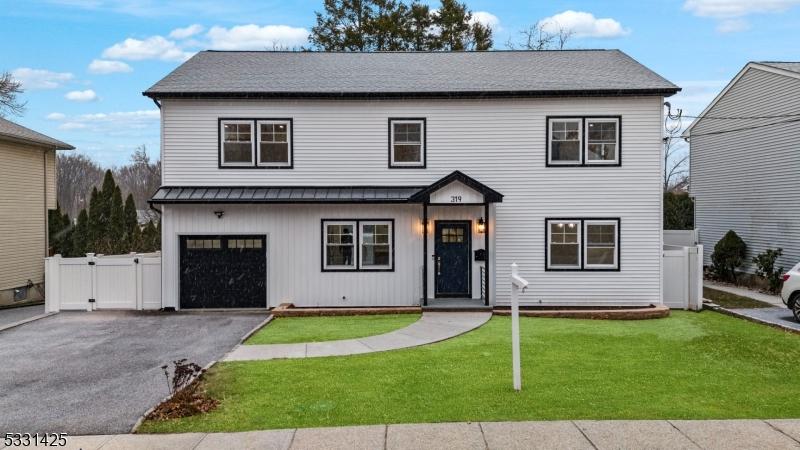 view of front of property with a front yard and a garage