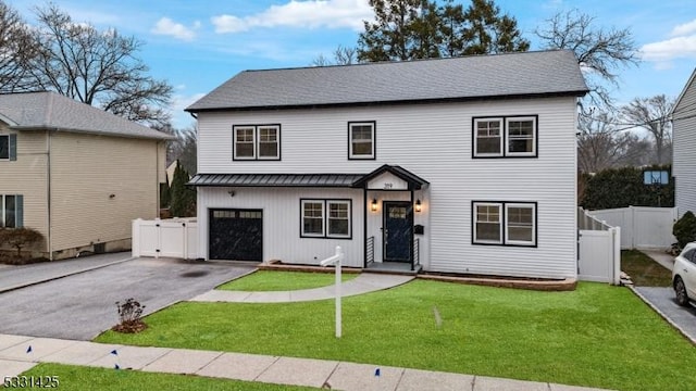 view of front of property with a front yard and a garage