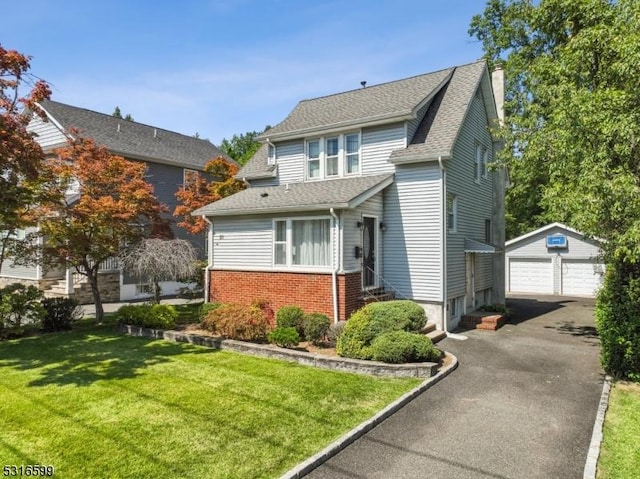 view of front of home featuring an outbuilding, a garage, and a front yard