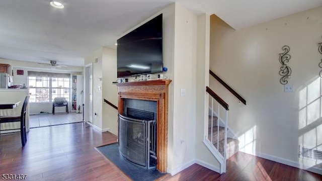 living room featuring ceiling fan and wood-type flooring