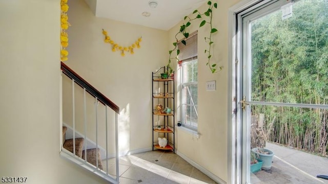 entryway with light tile patterned floors and plenty of natural light