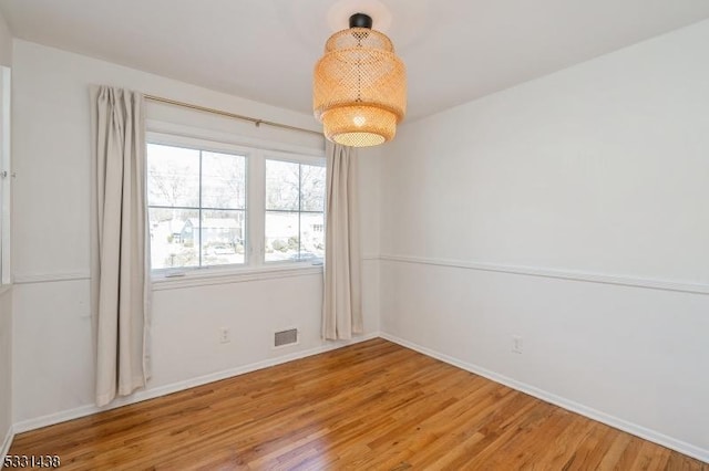 unfurnished room featuring hardwood / wood-style floors