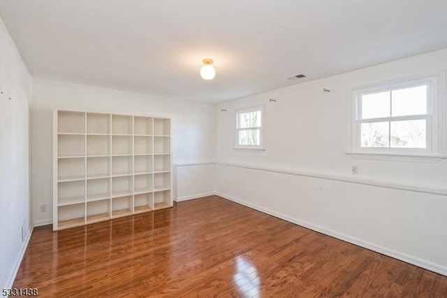 spare room featuring wood-type flooring