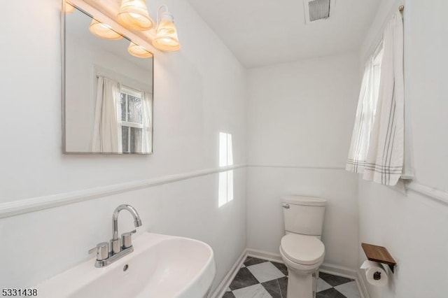 bathroom featuring toilet and sink