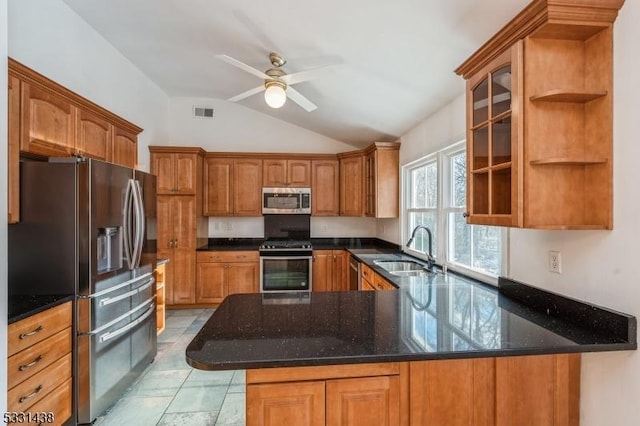 kitchen with lofted ceiling, sink, ceiling fan, kitchen peninsula, and stainless steel appliances