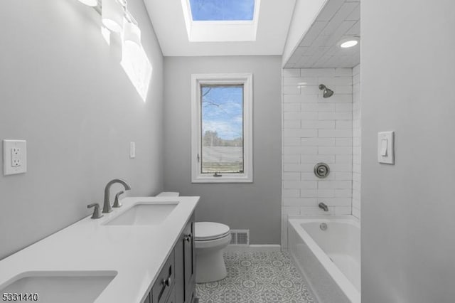 bathroom with visible vents, a sink, toilet, and double vanity