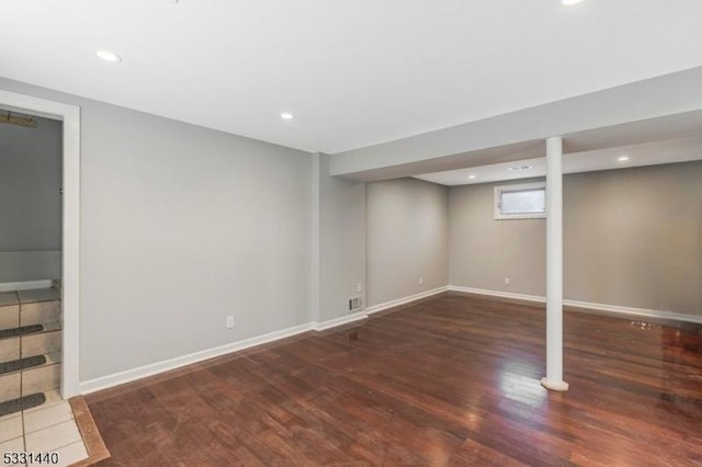 below grade area with recessed lighting, wood finished floors, and baseboards