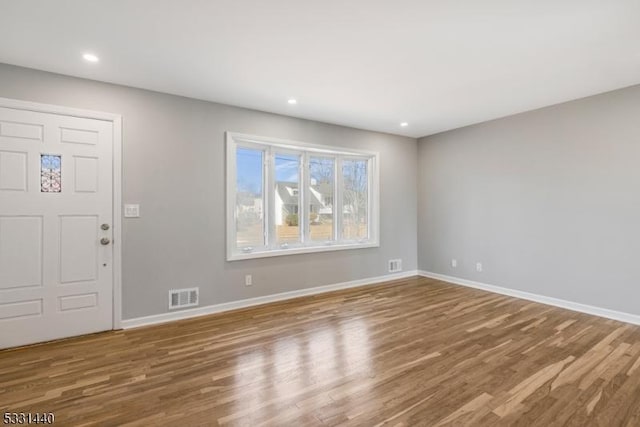 entrance foyer with baseboards, visible vents, wood finished floors, and recessed lighting