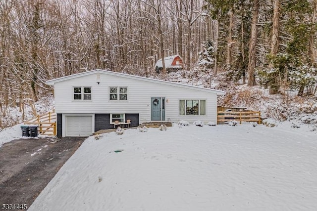 view of front of property with a garage and central air condition unit