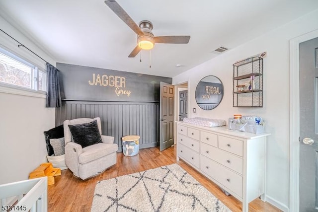 living area with ceiling fan and light wood-type flooring