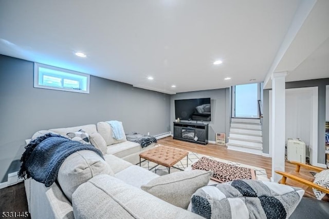 living room with wood-type flooring and a baseboard radiator