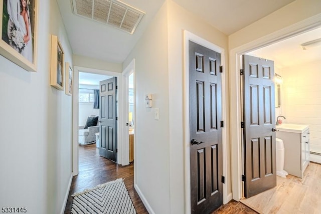 corridor featuring hardwood / wood-style floors and sink