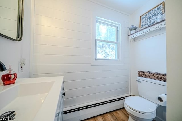 bathroom featuring hardwood / wood-style floors, vanity, a baseboard radiator, and toilet