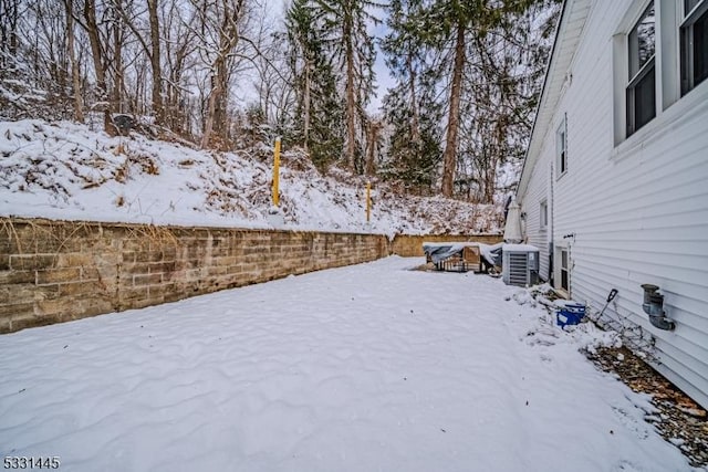 yard covered in snow featuring central AC