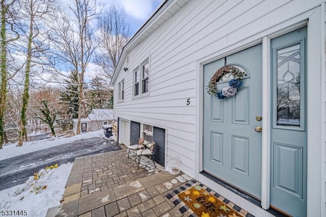 view of snow covered property entrance