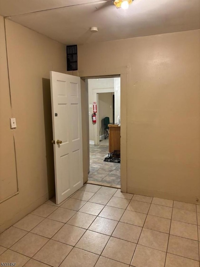 hall with light tile patterned flooring