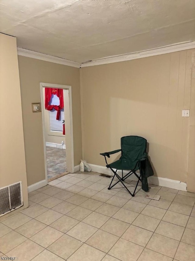 unfurnished room featuring light tile patterned floors and ornamental molding