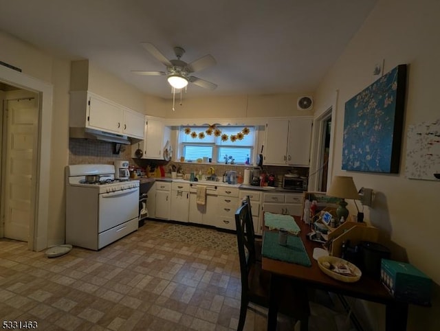 kitchen with ceiling fan, white cabinetry, white range with gas stovetop, and tasteful backsplash