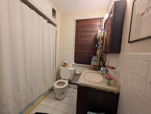 bathroom featuring a baseboard radiator, tile patterned floors, toilet, vanity, and tile walls