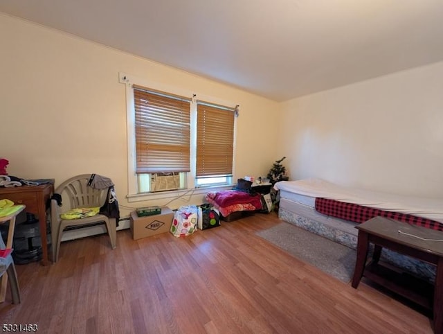 bedroom with hardwood / wood-style flooring