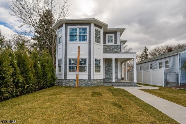 view of front of home featuring covered porch and a front lawn