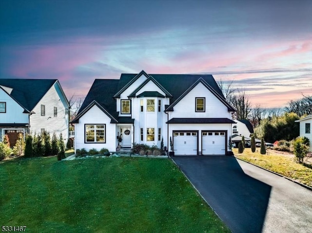 view of front of property featuring a yard and a garage