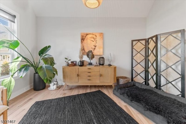 sitting room with light hardwood / wood-style flooring and vaulted ceiling